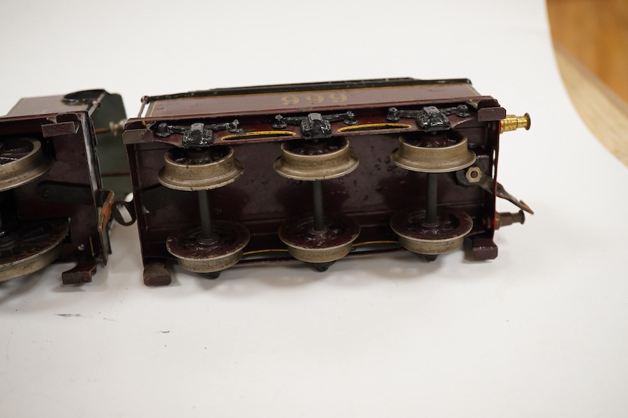 An 0 gauge Bing clockwork tinplate Midland Railway 4-4-0 tender locomotive, 999, in maroon livery with yellow and black lining and original clockwork mechanism